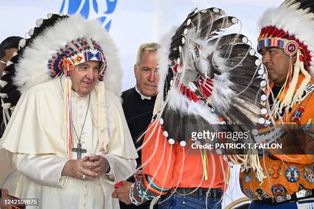 Pope Francis wears a headdress presented to him by Indigenous leaders during a meeting at Muskwa Park in Maskwacis, Alberta, Canada, on July 25,...