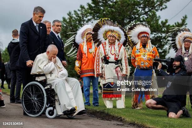 Pope Francis pauses in front of the site of the former Ermineskin Residential School, alongside the Maskwacis Chiefs, during his visit on July 25,...