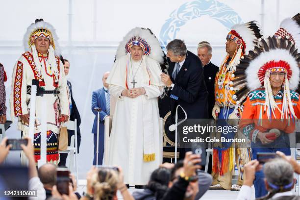 Pope Francis wears a traditional headdress that was gifted to him by indigenous leaders during his visit on July 25, 2022 in Maskwacis, Canada. The...