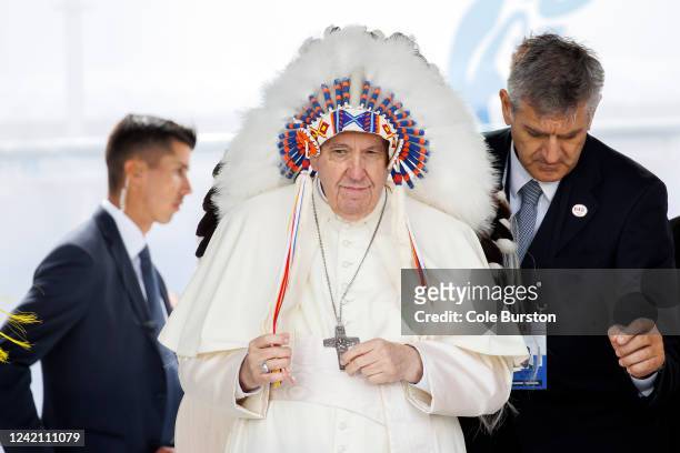 Pope Francis wears a traditional headdress that was gifted to him by indigenous leaders following his apology during his visit on July 25, 2022 in...