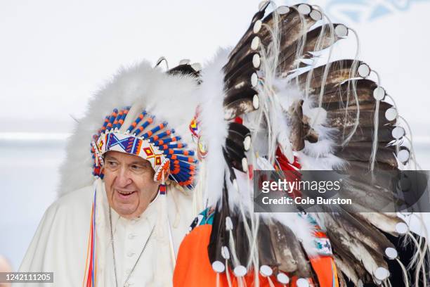 Pope Francis wears a traditional headdress that was gifted to him by indigenous leaders following his apology during his visit on July 25, 2022 in...