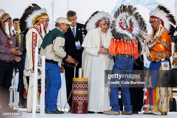 Pope Francis wears a traditional headdress that was gifted to him following his apology during his visit to Maskwacis, Canada on July 25, 2022. The...