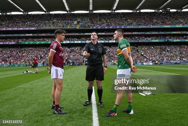 Dublin , Ireland - 24 July 2022; Referee Sean Hurson tosses a coin between the two captains, Seán Kelly of Galway, and Seán O'Shea of Kerry, before...