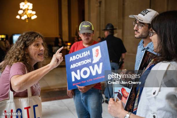 An abortion rights protester shouts at a group of anti-abortion activists at the Indiana State Capitol building on July 25, 2022 in Indianapolis,...