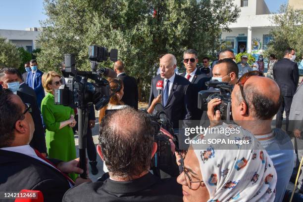 Tunisian President Kais Saied delivers a statement outside a polling station after casting his vote during the Tunisian constitutional referendum.