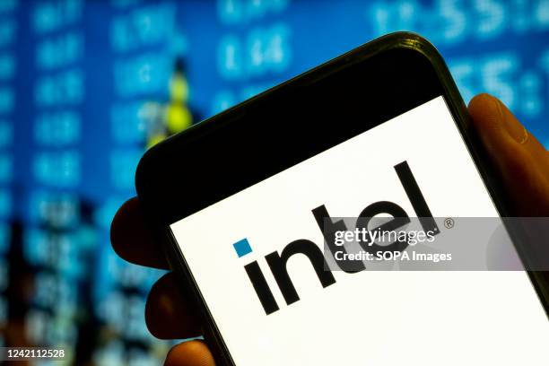 In this photo illustration, the American multinational corporation and microprocessor technology company, Intel logo is displayed on a smartphone...