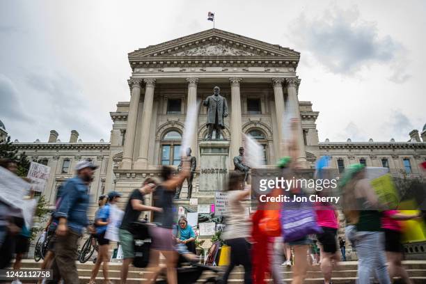 Abortion rights protesters march outside the Indiana State Capitol building on July 25, 2022 in Indianapolis, Indiana. Activists are gathering during...