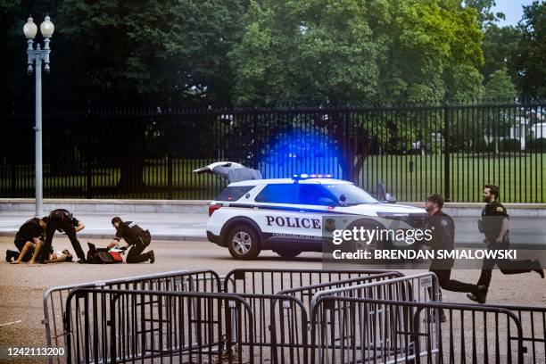 Graphic content / Members of the Secret Service render first aid after restraining a woman on Pennsylvania Avenue in front of the White House on July...