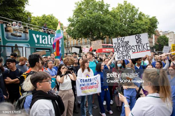 Healthcare professionals, including doctors and nurses, hold placards expressing their opinion and chant slogans along Downing Street. NHS doctors,...