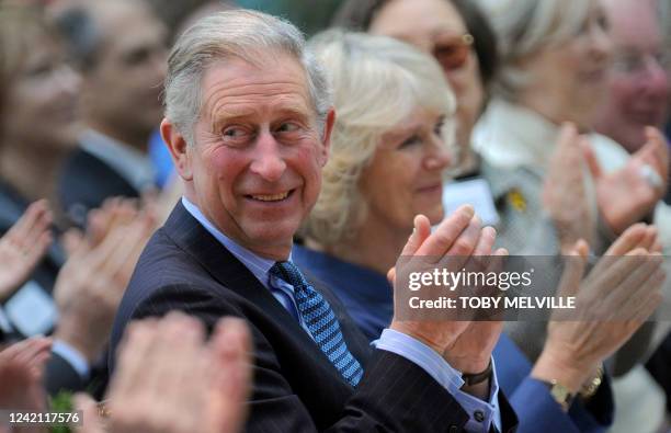 Britain's Prince Charles and Camilla, Duchess of Cornwall, react whilst watching a concert at the Royal Opera House in central London on November 14,...