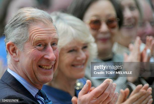 Britain's Prince Charles and Camilla, Duchess of Cornwall , react whilst watching a concert at the Royal Opera House in central London on November...