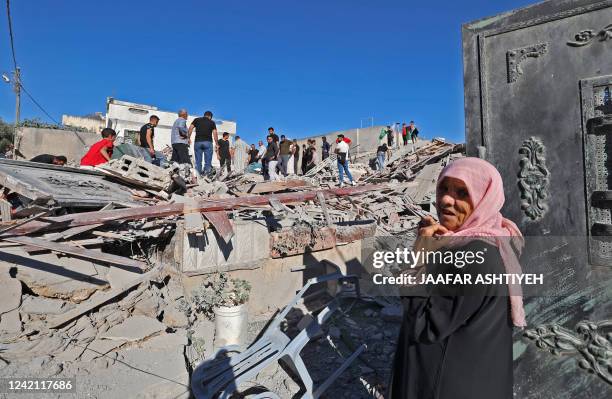 People gather after Israeli forces demolished the home of Palestinian militant Yehya Miri, accused of carrying out a deadly shooting attack in the...