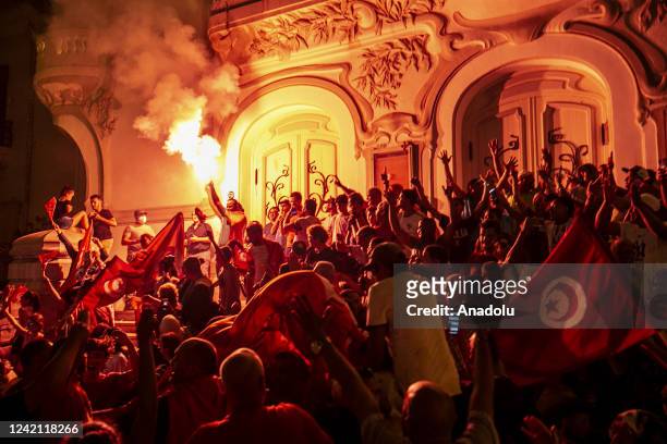 Supporters of Tunisian President Kais Saied celebrate the almost certain victory of the 'yes' vote in a referendum on a new constitution, after the...