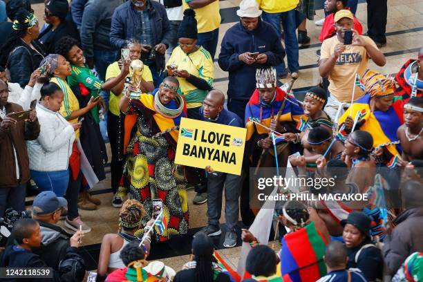 Fans sing and dance as they wait for the South African senior national women's team players to arrive at OR Tambo International Airport as they...