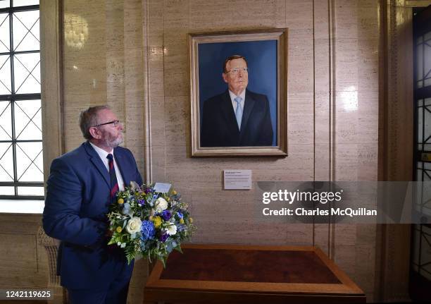 Ulster Unionist party leader Doug Beattie lays flowers underneath a portrait of former UUP leader and Northern Ireland First Minister Lord David...