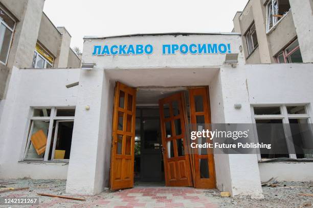 The 'Welcome' sign in Ukrainian hangs over the smashed doors to a school ruined by the shelling of Russian troops, Chuhuiv district, Kharkiv Region,...