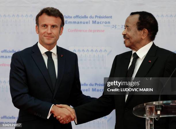 France's President Emmanuel Macron and Cameroon's President Paul Biya shake hands during a press conference in Yaounde, on July 26, 2022. Macron in...