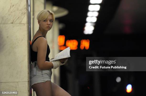 Woman holds a book at the Kyiv Metro during a flash mob of the Kyiv Book Club, Kyiv, capital of Ukraine. This photo cannot be distributed in the...