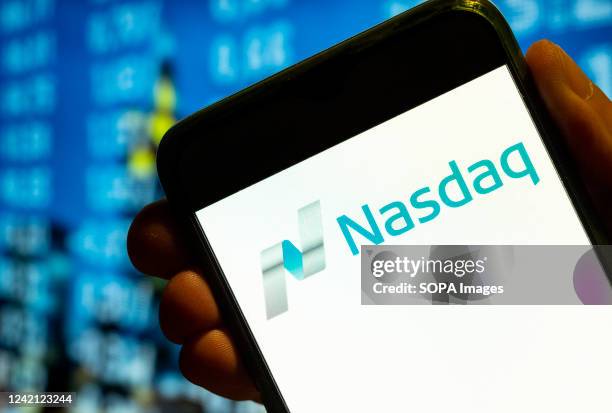 In this photo illustration, the American stock exchange index, Nasdaq logo is displayed on a smartphone screen.