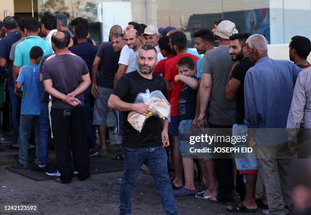 Lebanese line up in front of a bakery in the Safra highway north of Beirut on July 26, 2022. - Lebanon's parliament approved today a $150 million...