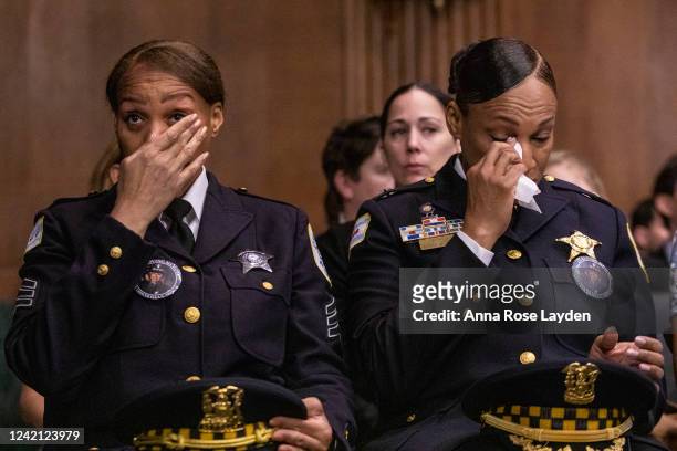 Officers from the Chicago Police department, wearing buttons that depict fallen Chicago police officer Ella French, tear up during a Senate Judiciary...