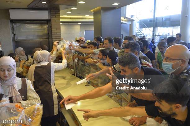 People are seen waiting in line for bread at a bakery in Beirut, Lebanon on July 25, 2022. Due to the wheat shortage the Lebanese Parliament approved...