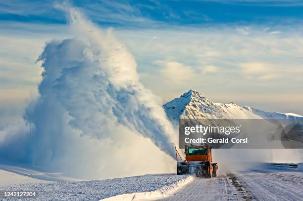 soplador de nieve, arado de nieve en el haines hignway, yukon, canadá, máquina naranja, nieve soplando - quitanieves fotografías e imágenes de stock