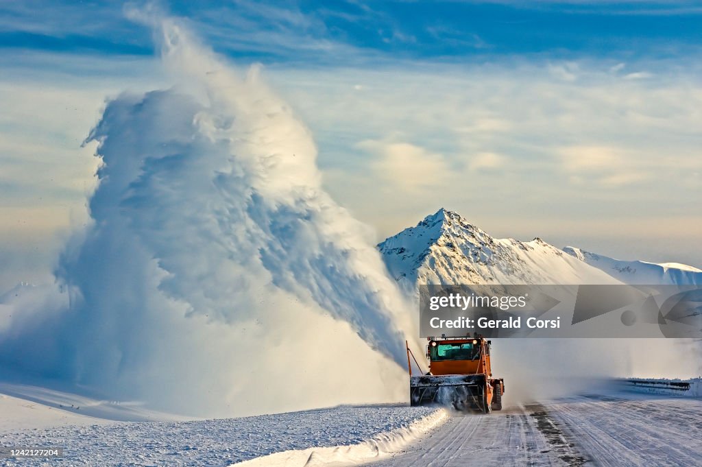 Snow blower, Snow Plow on the Haines Hignway, Yukon, Canada, orange machine, snow blowing