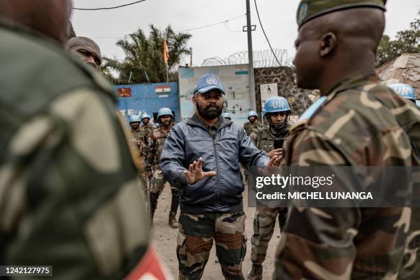 An Indian officer with the UN peacekeeping mission MONUSCO gestures as he talks with Congolese Army officers in front of a UN base in Goma on July...