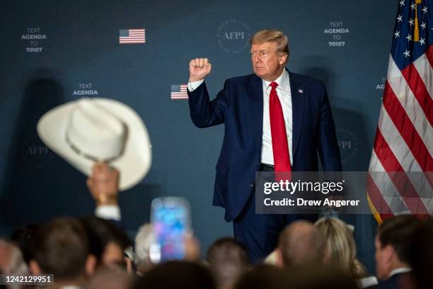 Former U.S. President Donald Trump acknowledges the crowd after speaking during the America First Agenda Summit, at the Marriott Marquis hotel July...