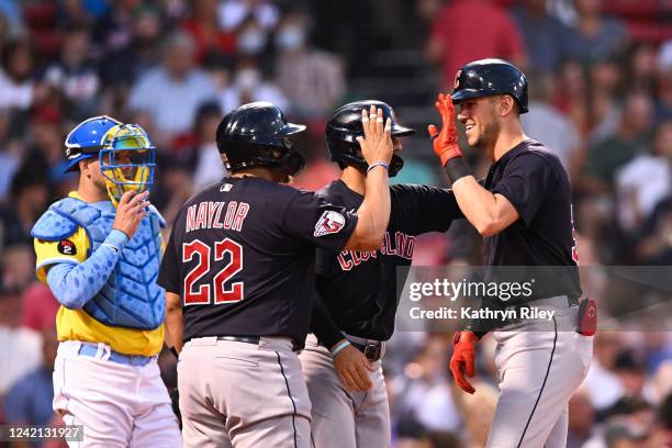 Nolan Jones of the Cleveland Guardians celebrates his three-run home run with Josh Naylor and Andres Gimenez in the third inning against the Boston...