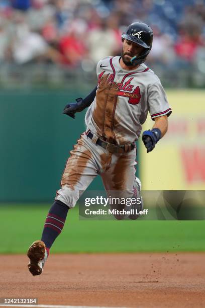 Dansby Swanson of the Atlanta Braves rounds third base on his way to scoring a run in the top of the first inning against the Philadelphia Phillies...
