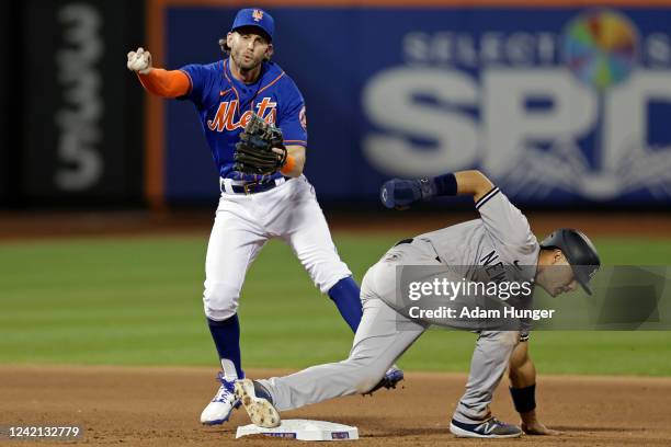 Isiah Kiner-Falefa of the New York Yankees is safe at second base as he collides with Jeff McNeil of the New York Mets during the fourth inning at...