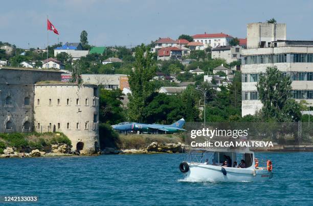 People enjoy a boat tour on the Black Sea off Sevastopol, the largest city on the Crimean Peninsula and its most important port and naval base, on...