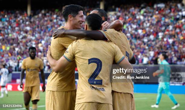 Robert Lewandowski of FC Barcelona celebrates with teammates including Ousmane Dembele after Dembele scored his second goal of the match during the...