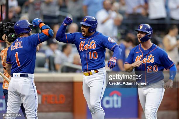 Eduardo Escobar of the New York Mets celebrates with Jeff McNeil of the New York Mets and Pete Alonso of the New York Mets after hitting a 2-run home...