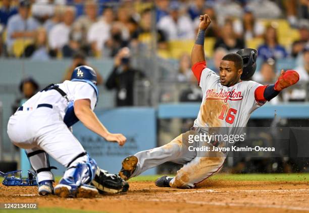 Victor Robles of the Washington Nationals is tagged out at home by Will Smith of the Los Angeles Dodgers on a throw from Mookie Betts of the Los...