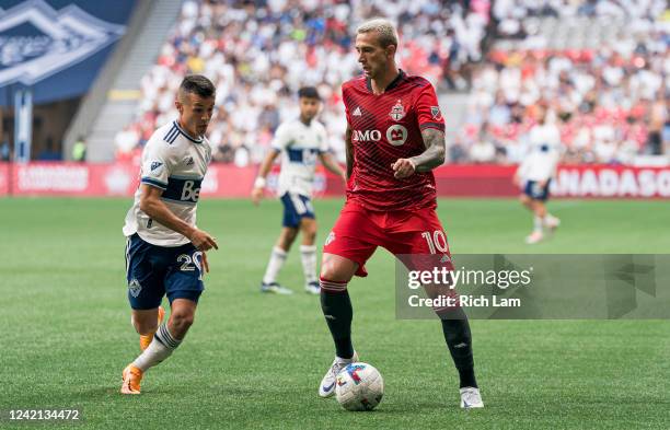 Federico Bernardeschi of the Toronto FC looks to pass the ball while pressured by Andres Cubas of the Vancouver Whitecaps FC during the first half of...