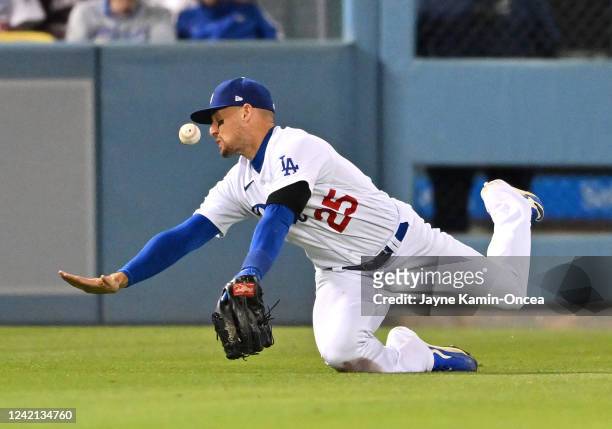 Triple by Luis Garcia of the Washington Nationals gets past a diving Trayce Thompson of the Los Angeles Dodgers in the fourth inning at Dodger...