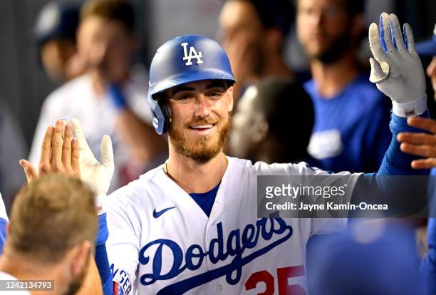 Cody Bellinger of the Los Angeles Dodgers is greeted in the dugout after hitting a solo home run in the fifth inning against the Washington Nationals...