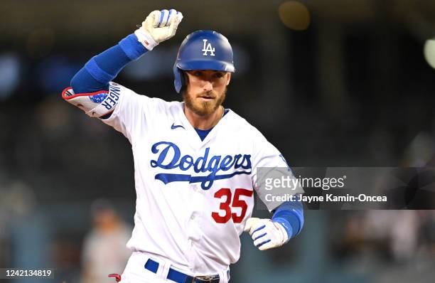 Cody Bellinger of the Los Angeles Dodgers gestures to the dugout as he rounds the bases after hitting a solo home run in the fifth inning against the...