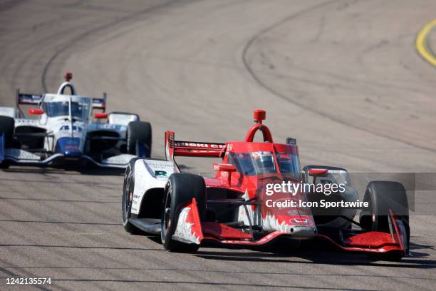 IndyCar series drivers Marcus Ericsson and Jimmie Johnson drive coming out of turn 4 towards the start finish line during the Hy-Vee Salute To...