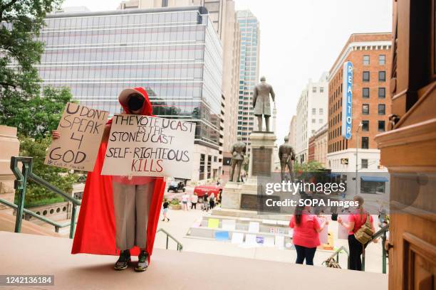 An abortion-rights protester dressed as a cast member of the Handmaidís Tale protests on the steps of the Indiana Statehouse. As the legislature is...