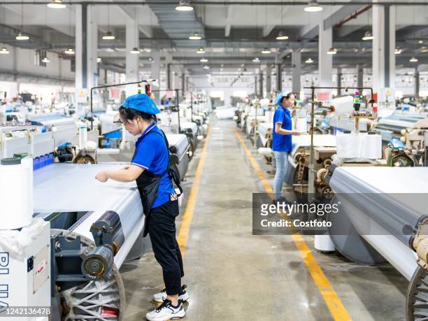 Worker makes orders for chemical fiber products for export at a textile production workshop in Hai 'an, East China's Jiangsu province, July 27, 2022....
