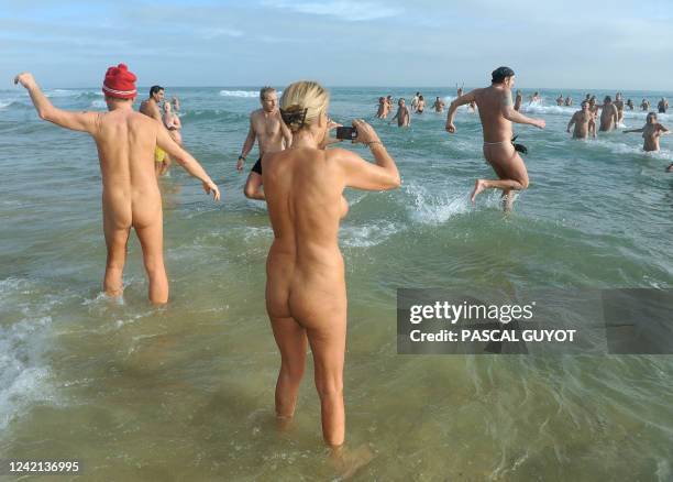 Some of the 300 people take part in a traditional bath ending the year, on December 31, 2009 on the nudist beach of Le Cap d'Agde, southern France....