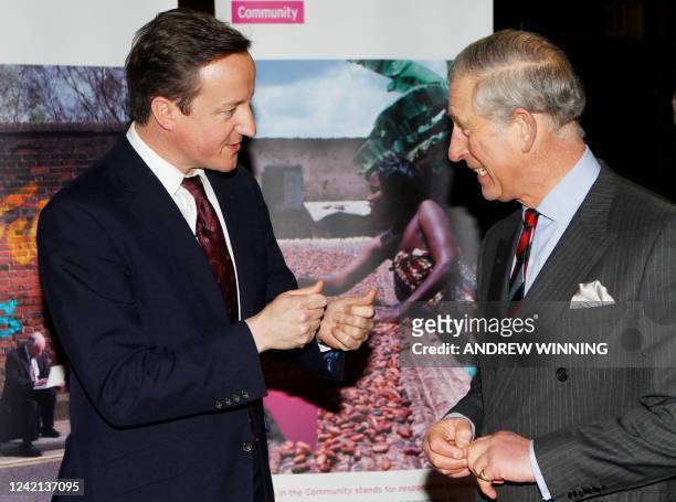 Britain's Prime Minister David Cameron speaks with Britain's Prince Charles at a meeting of business leaders in London on December 2, 2010. England...
