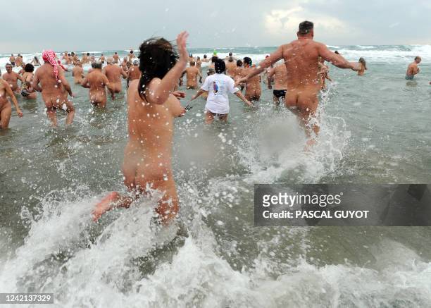 Some of the 300 people take part in a traditional bath ending the year, on December 31, 2010 on the nudist beach of Le Cap d'Agde, southern France....
