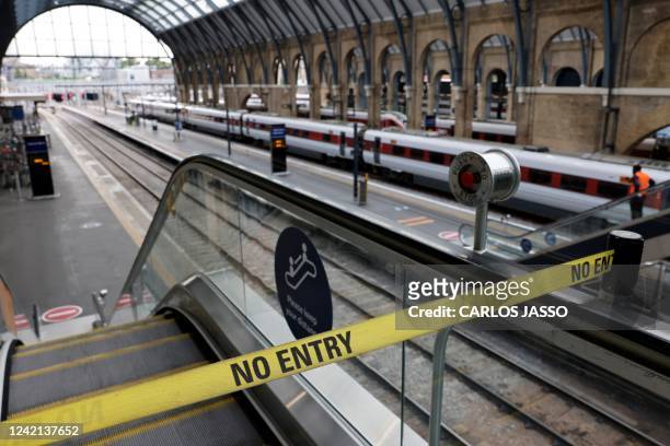 No Entry" belt barrier blocks access to a platform at King's Cross railway station in London on July 27, 2022 as fresh railway strikes hit the...