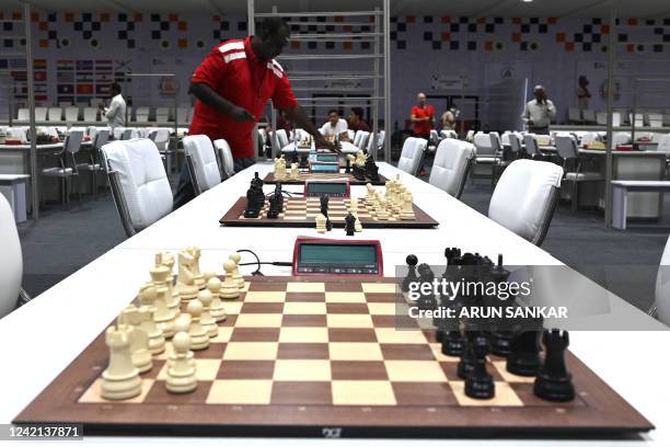 Volunteer sets a timer at the playing area ahead of the start of the 44th Chess Olympiad 2022, in Mahabalipuram on July 27, 2022.