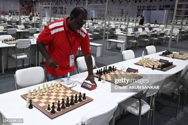 Volunteer sets a timer at the playing area ahead of the start of the 44th Chess Olympiad 2022, in Mahabalipuram on July 27, 2022.